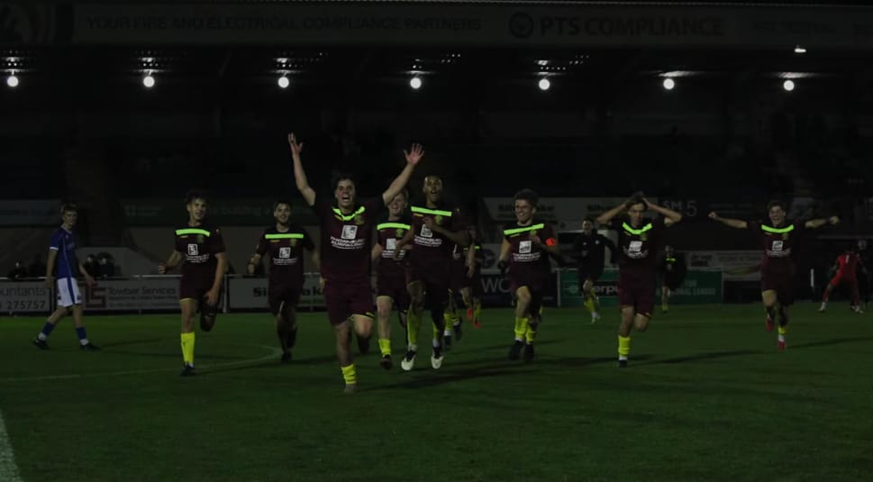 Idris celebrating with his team-mates after a win